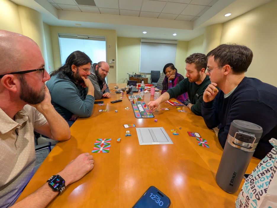 Members of TSO around a table playing a board game